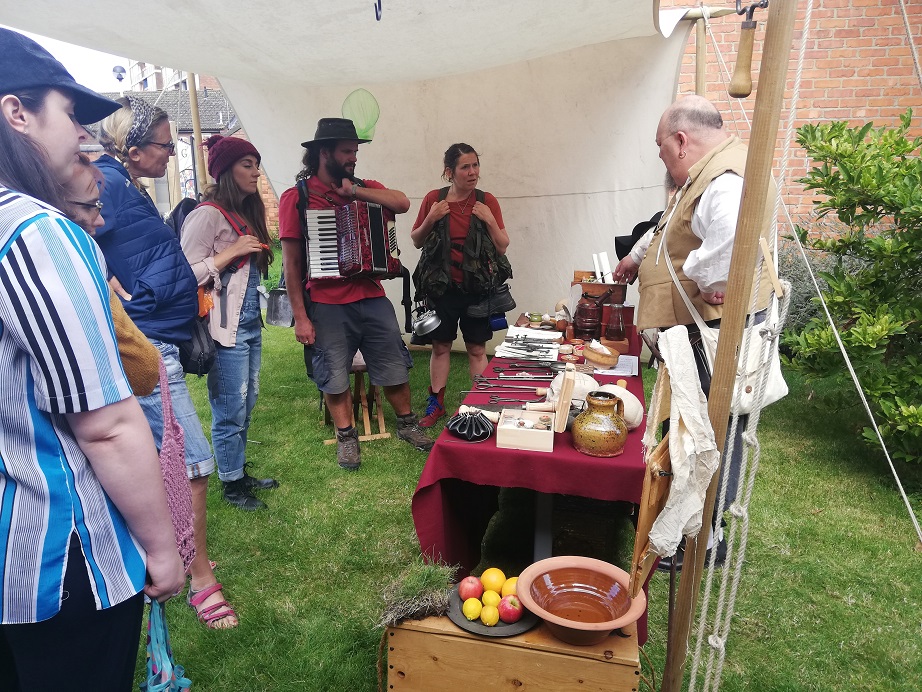 John Putley, resident barber surgeon, talking to the Pitch Up group. He is pointing to the different tools used by surgeons in full 17th Century costume