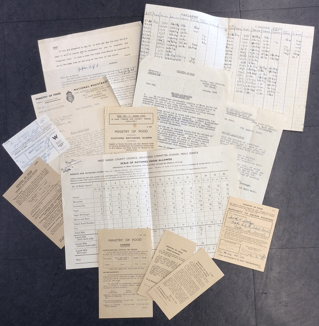 Image shows ten or so leaflets and notes regarding the supply of food to the school, including scale of rationed foods allowed, orders of margarine and cooking fat needed each month, requests for more allowances and notices on rationing portions