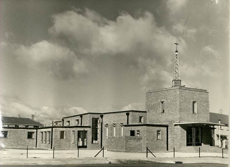 Exterior photograph of the brick and square block style church.