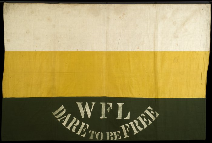 Flag shape with three horizontal stripes, white (top), yellow (middle), dark green (bottom), with 'WFL Dare to be Free' printed in white on the bottom stripe