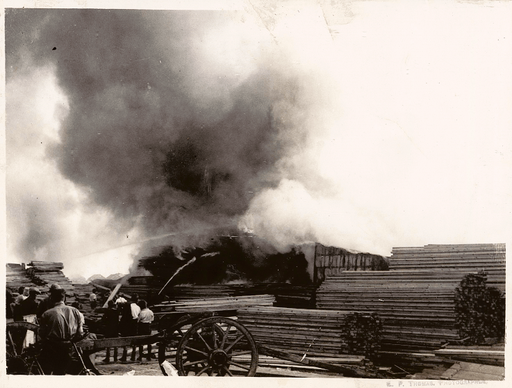 Smoke and firefighters at the wharf tackling the fire