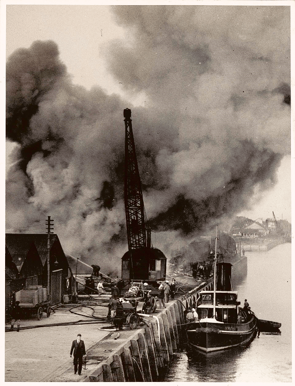 Smoke and firefighters at the wharf tackling the fire