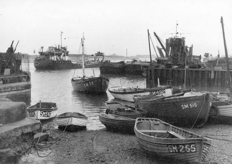 Small boats moored on the banks of the harbour