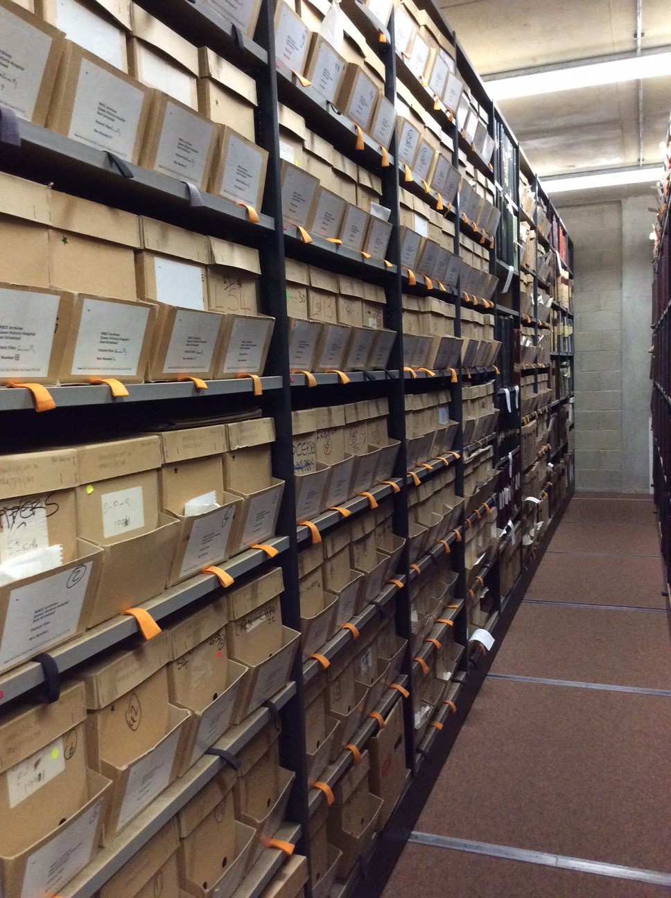 Photo inside Archive Strongroom showing the QVH archive on the shelves