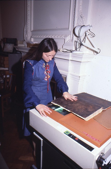 Woman copying a volume on a large Xerox machine