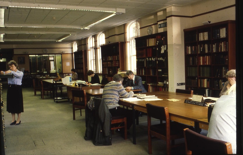 Researchers consulting documents at desks