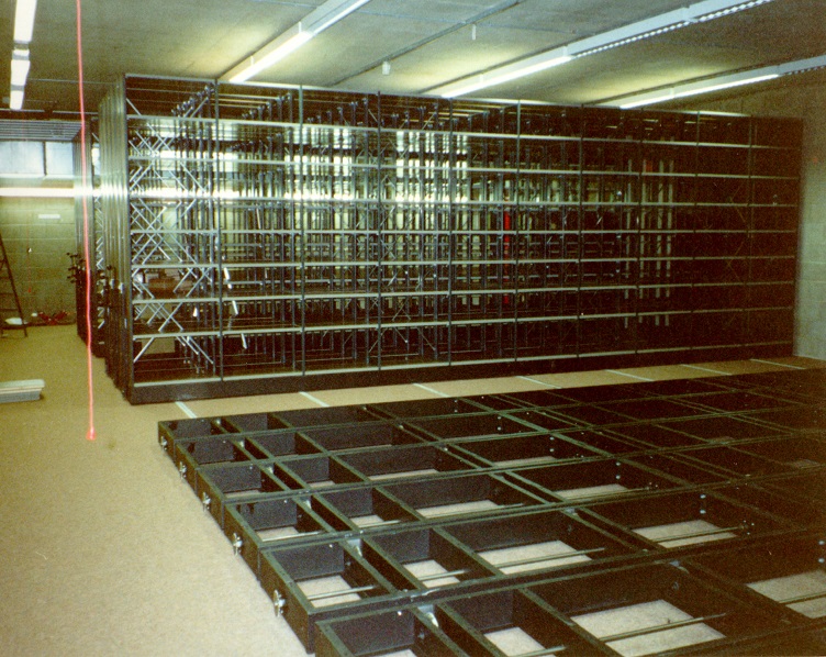 Colour photograph showing several bays of mobile racking completed and the base units installed for the next bays
