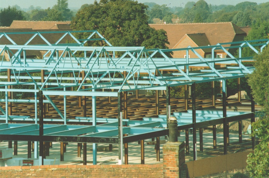 Colour photograph showing steel framework of building, no brickwork