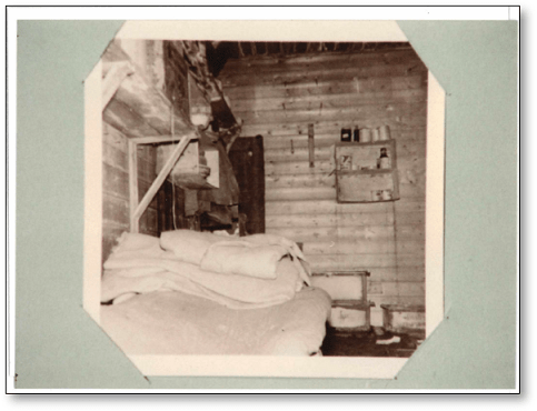 Sepia photograph of rustic sleeping quarters.