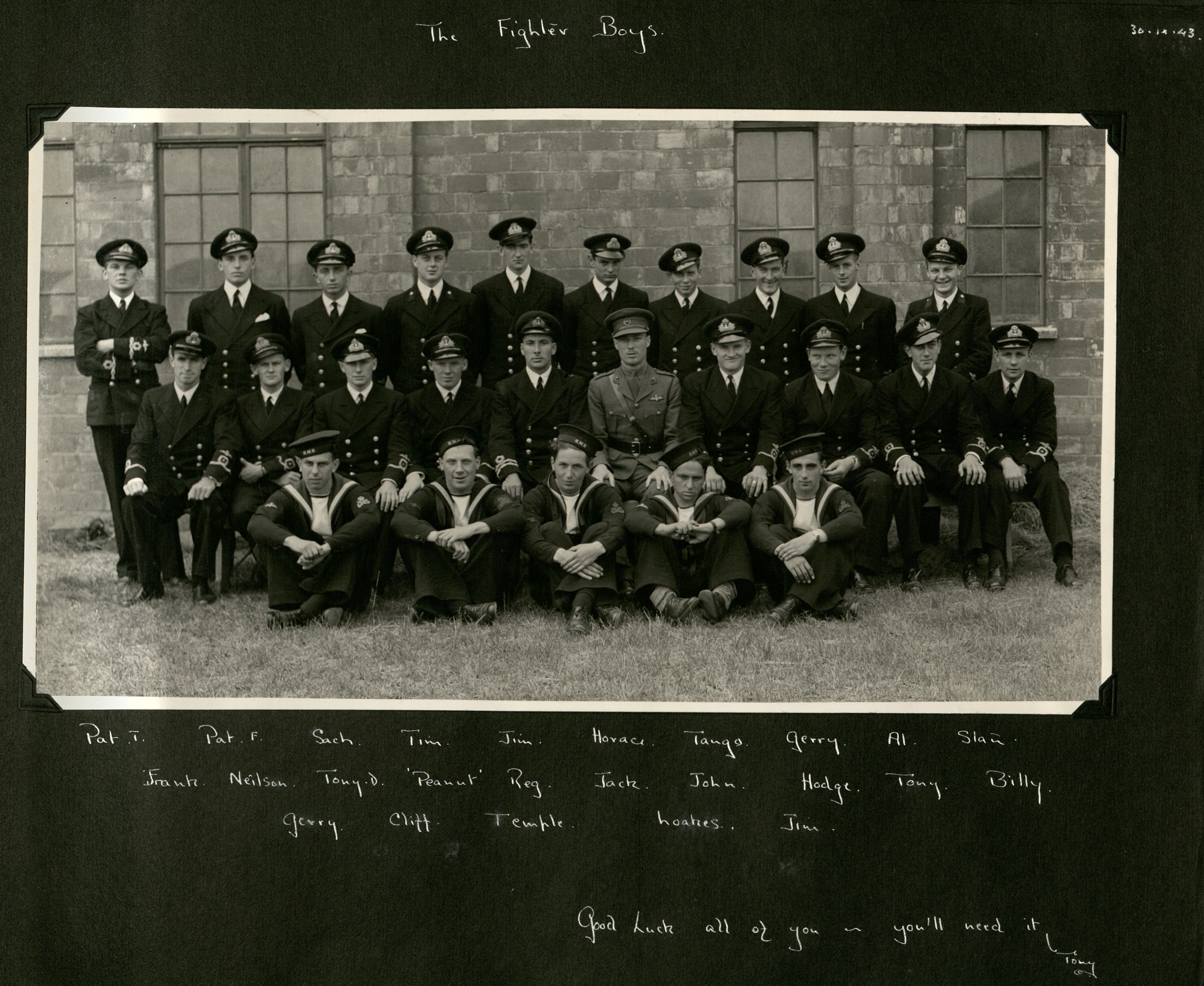 Three rows of naval fighter pilots in uniform. Underneath their first names are listed.
